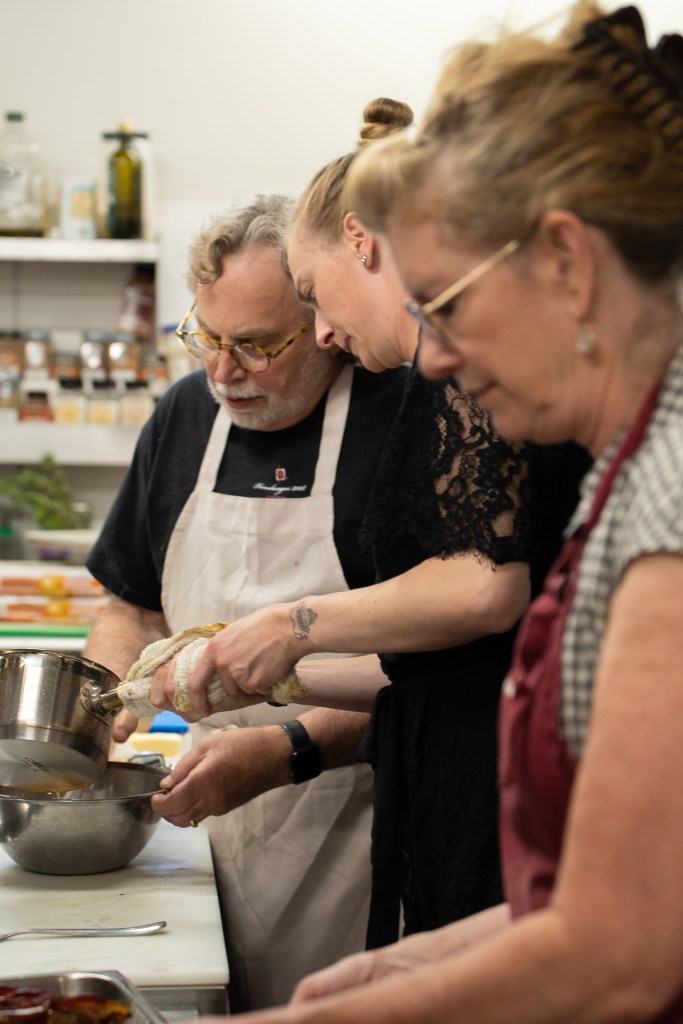Mark Vlossak with his daughter Makenzie and his wife Vickianne prepping food.